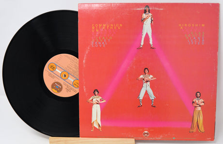 Vinyl record with a colorful album cover featuring people in a geometric design.