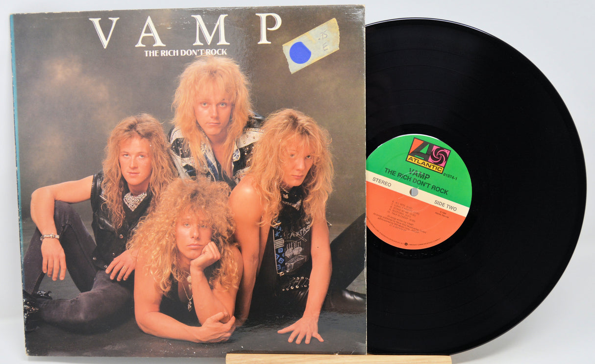 Vinyl record with cover featuring a band and record label visible