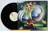 Vinyl record with a colorful album cover featuring people and a dog.