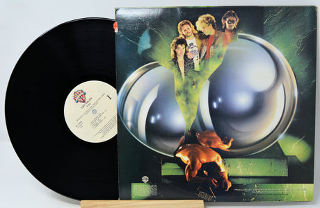 Vinyl record with a colorful album cover featuring people and a dog.