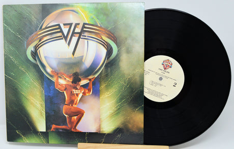 Vinyl record with a colorful cover featuring a person holding a sphere, on a white background.