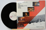 Vinyl record with cover featuring a musician playing guitar, on a white background