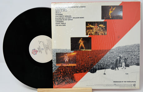 Vinyl record with cover featuring a musician playing guitar, on a white background