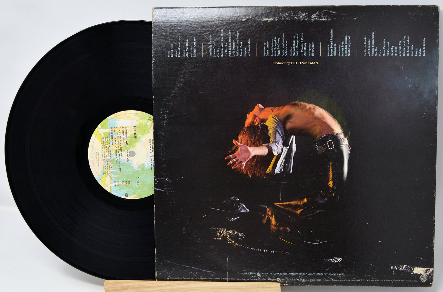 Vinyl record with cover featuring a person and text on a light gray background