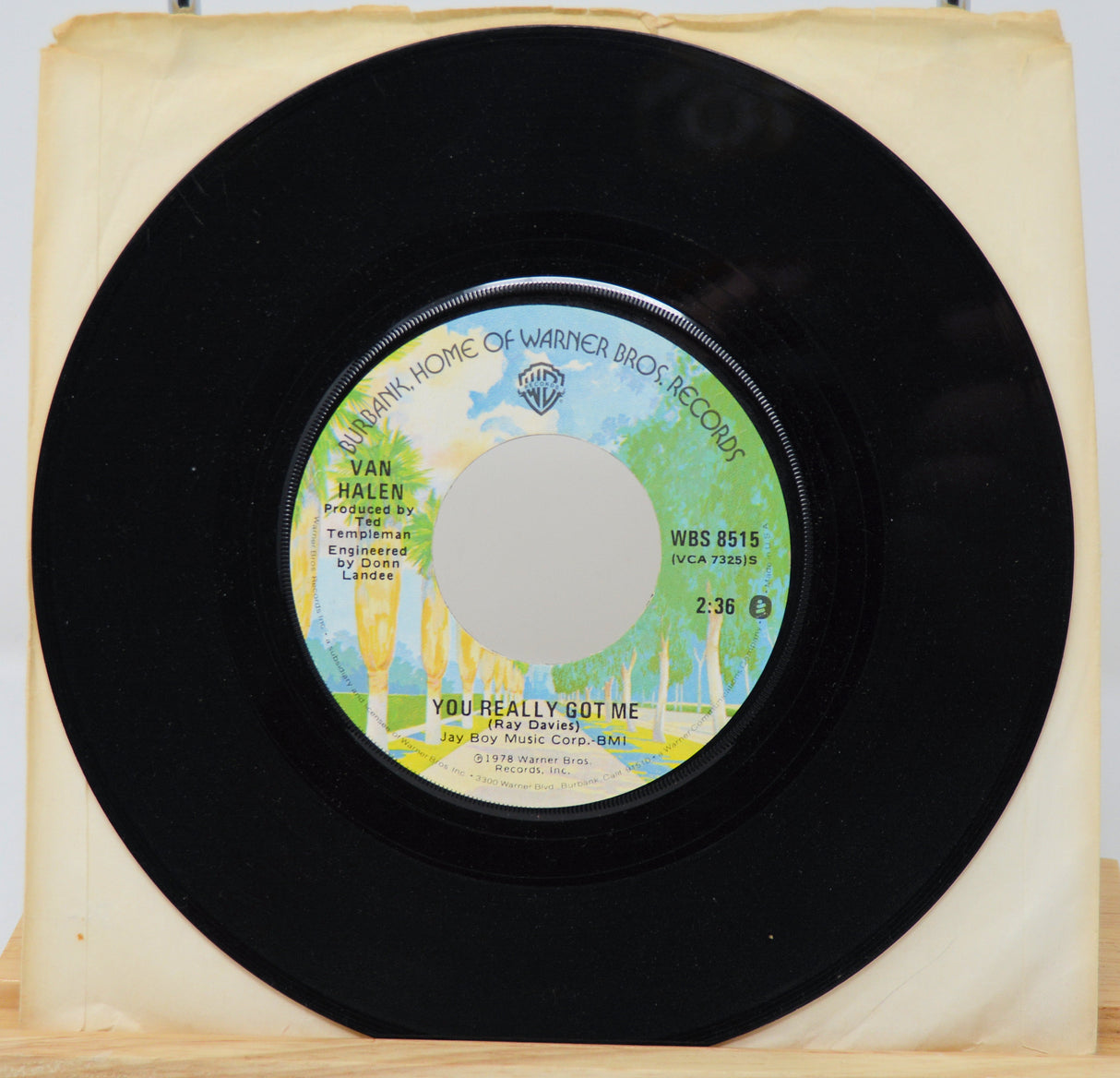 Vinyl record with a colorful label on a wooden surface