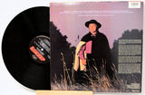 Vinyl record with cover featuring cloud design and album titles.