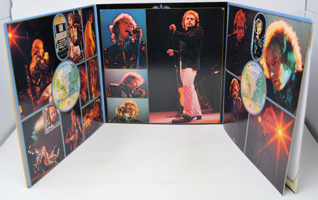 Open book with images of a person on stage and various other images on a white background