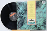 Vinyl record with a textured cover featuring an alien spaceship illustration.