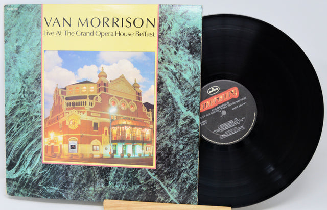Vinyl record with cover featuring Van Morrison concert details on a textured surface