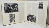 Open book with black and white photographs and text on a white background