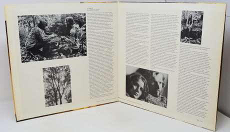 Open book with black and white photographs and text on a white background