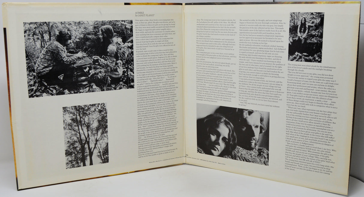 An open vintage book or magazine spread, showing two cream-colored pages filled with dense black text and several black-and-white photographs, photographed against a light neutral background.