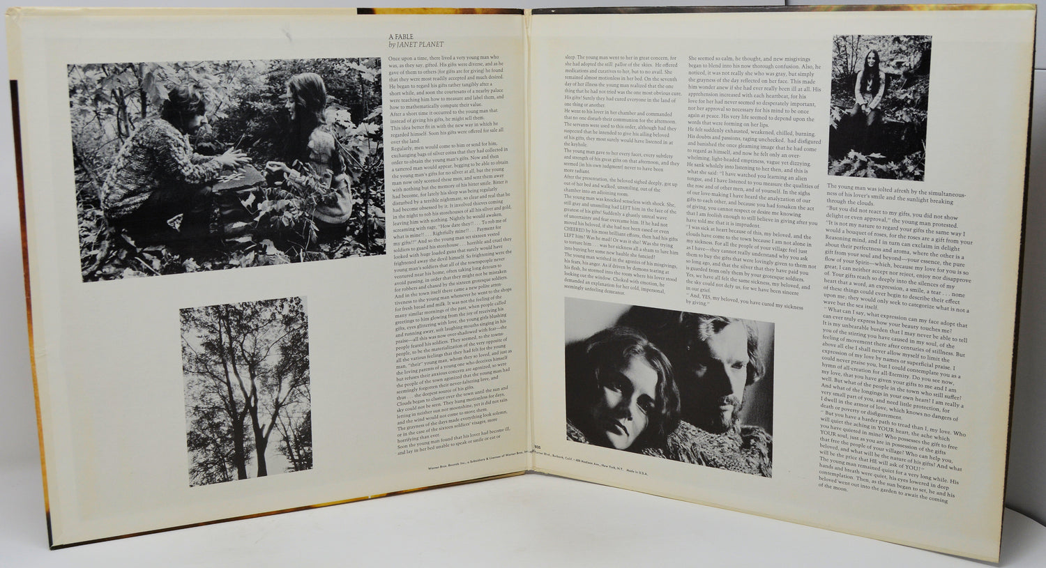 An open vintage book or magazine spread, showing two cream-colored pages filled with dense black text and several black-and-white photographs, photographed against a light neutral background.