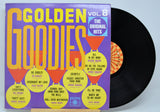 Vinyl record with colorful 'Golden Goodies' album cover on a light blue background