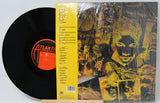 Vinyl record with a colorful cover featuring a face and text, including an 'Atlantic' label.