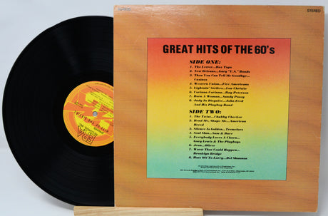 Vinyl record with cover displaying 'Great Hits of the 60's' tracklist on a gradient background