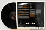 Vinyl record with a detailed cover displaying text and graphics on a white background