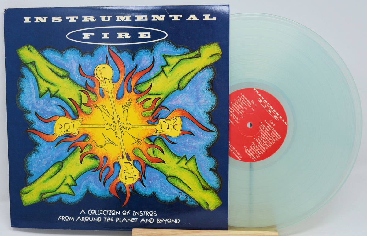 Instrumental Fire vinyl record album with its illustrated cover jacket and a translucent pale green record partially visible behind it on a white background.