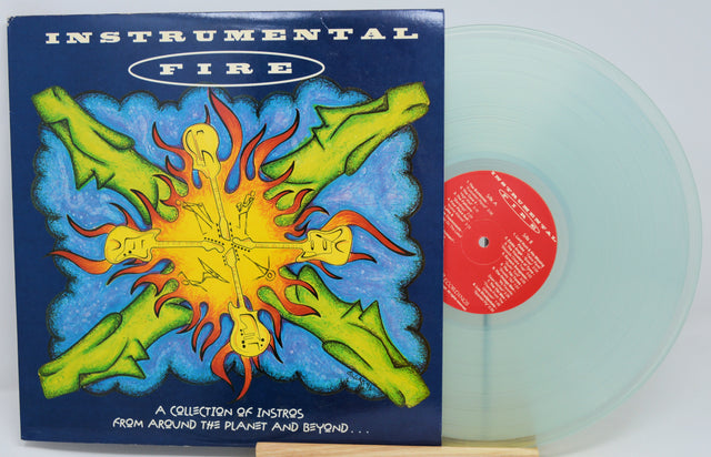 Instrumental Fire vinyl record album with its illustrated cover jacket and a translucent pale green record partially visible behind it on a white background.