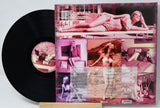 Vinyl record with a colorful album cover featuring images of a woman.