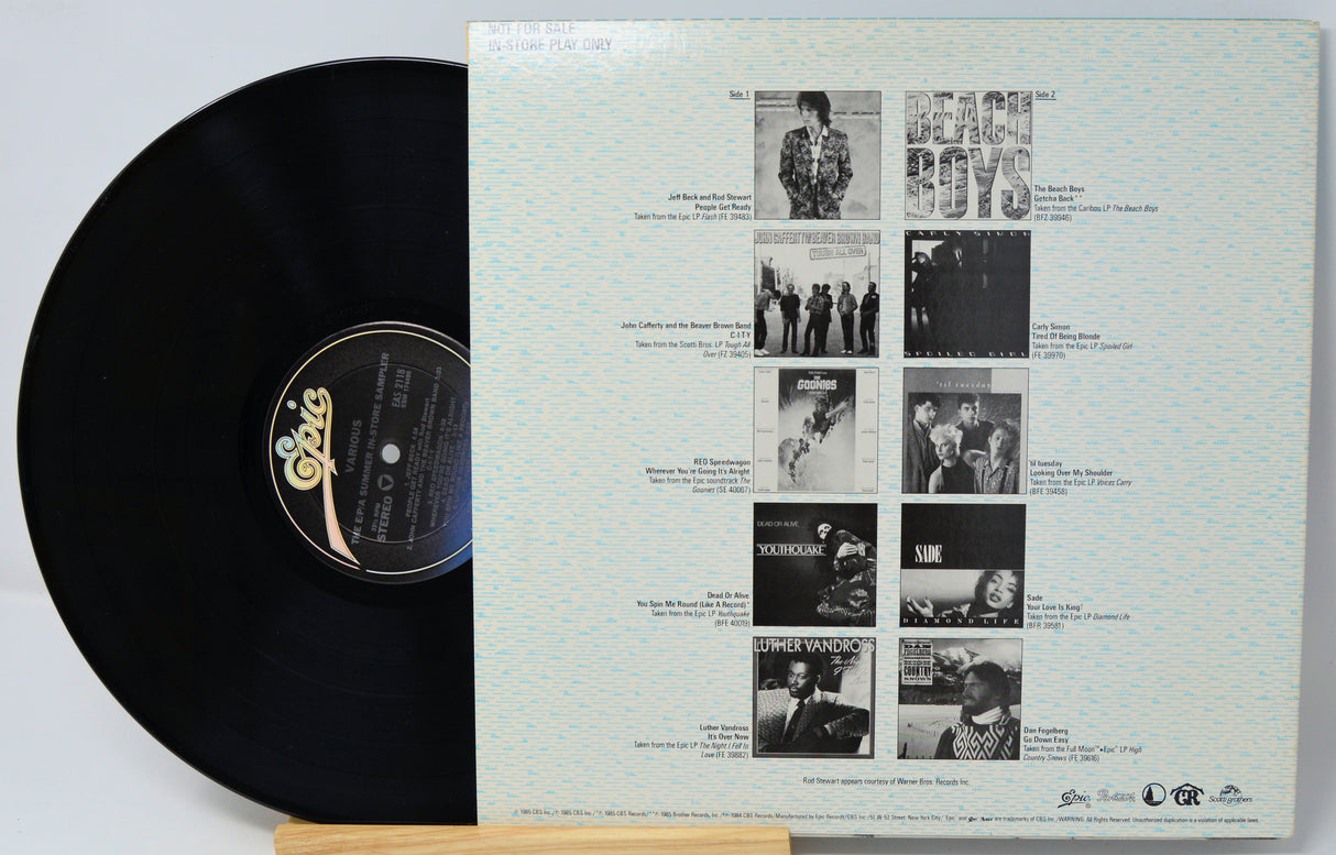 Vinyl record with a white cover featuring black and white images and text.