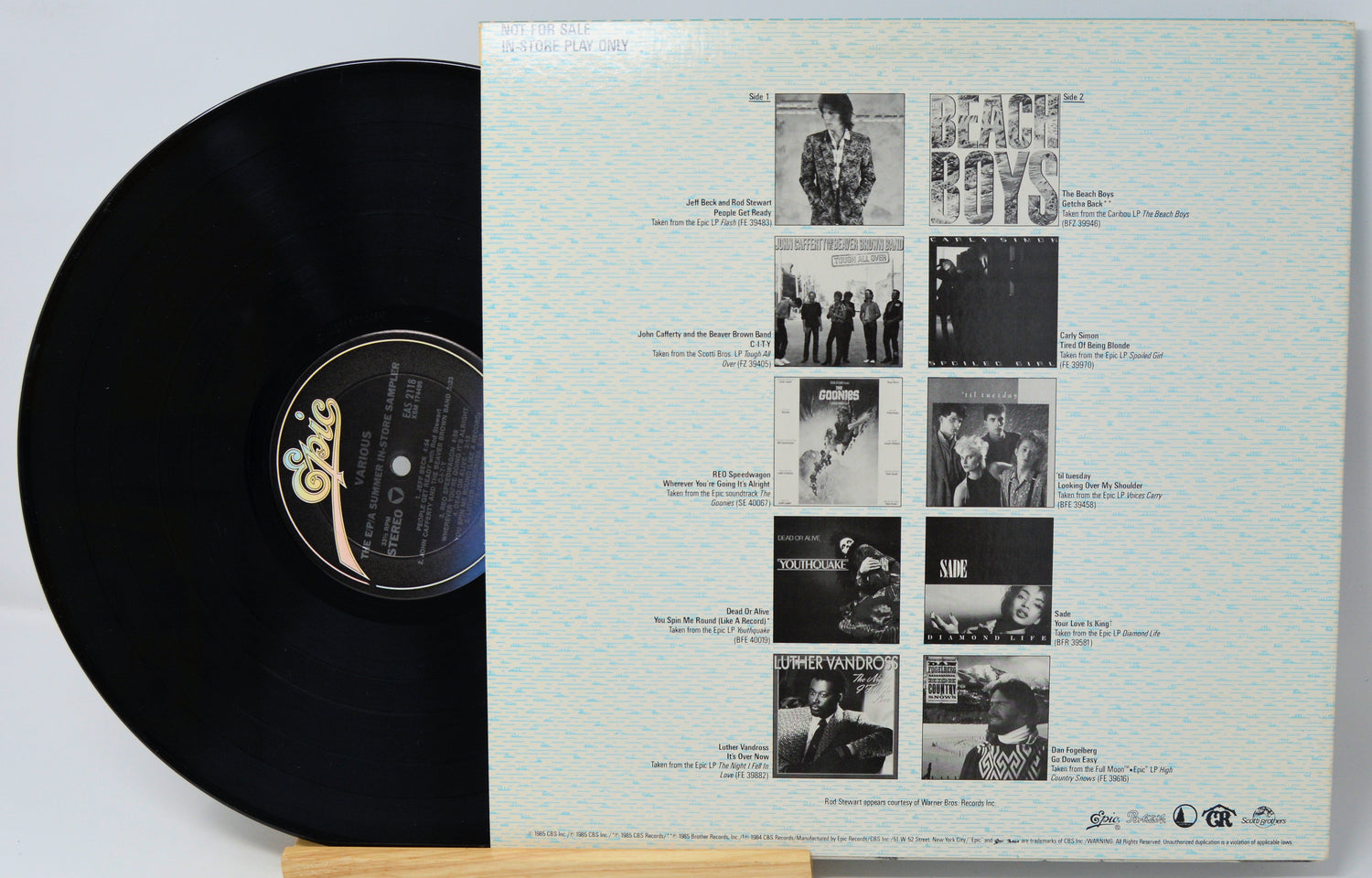 Vinyl record with a white cover featuring black and white images and text.