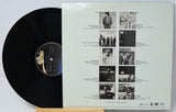 Vinyl record with a white cover featuring black and white images and text.