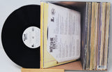 Vinyl record with a book-like cover on a white background