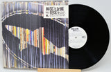 Vinyl record with colorful sleeve and visible label on a white background