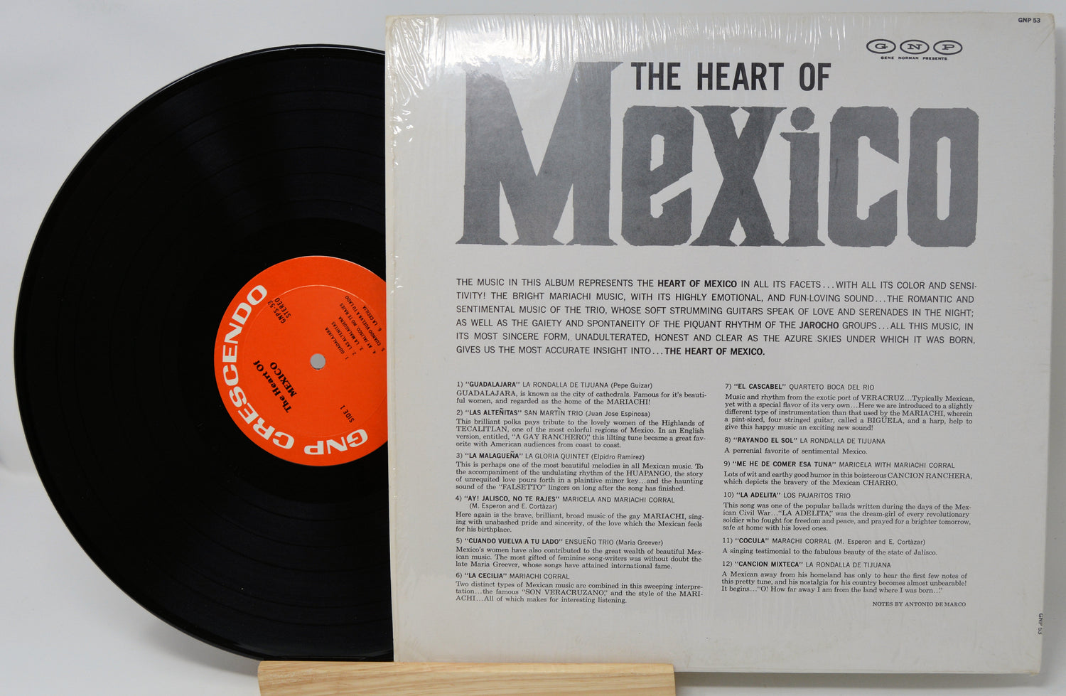 Vinyl record with a black disc and a white cover featuring text and an orange label.