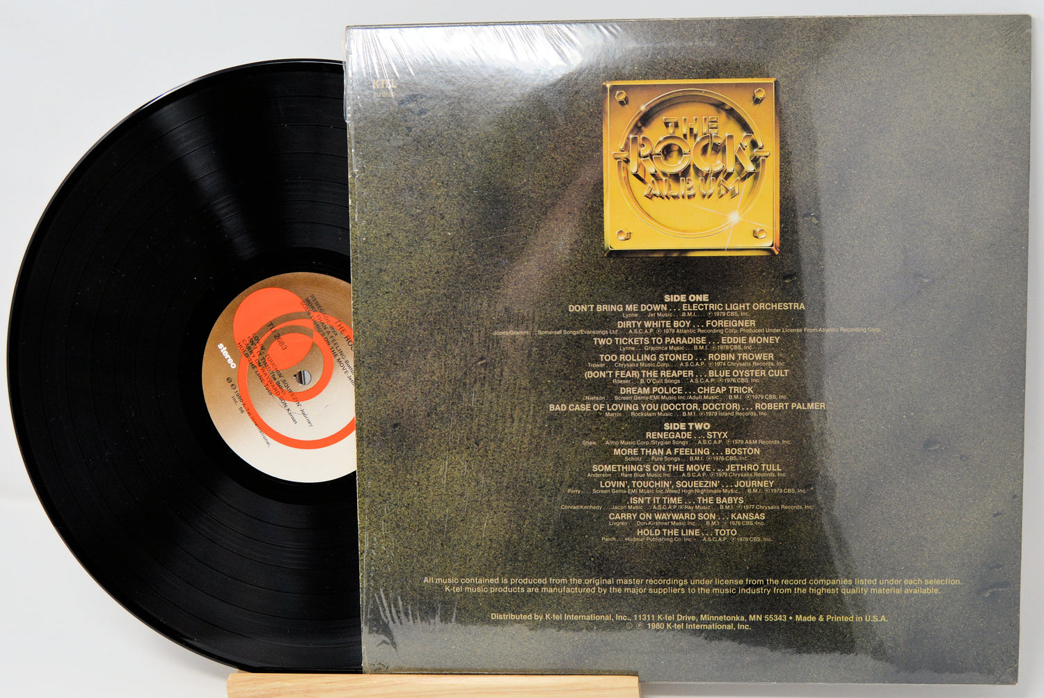 Vinyl record with gold label and black disc on a gray background