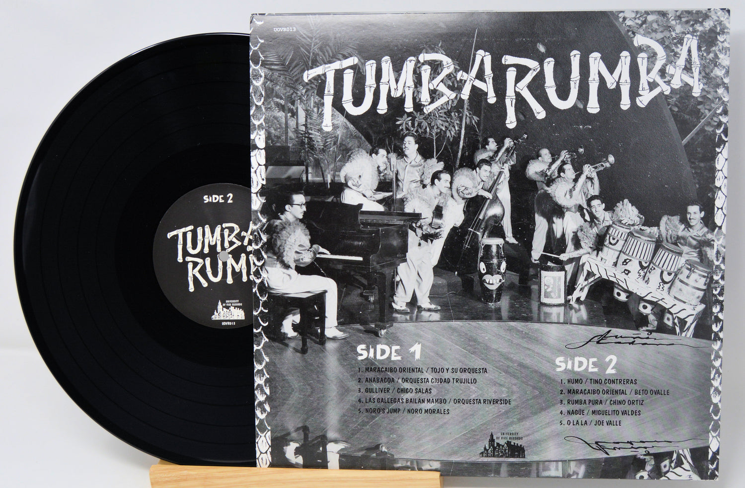 Vinyl record with cover featuring a band and text 'Tumba Rumba' on a light gray background.