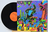 Vinyl record with a colorful, psychedelic-style cover featuring a gorilla and cityscape.