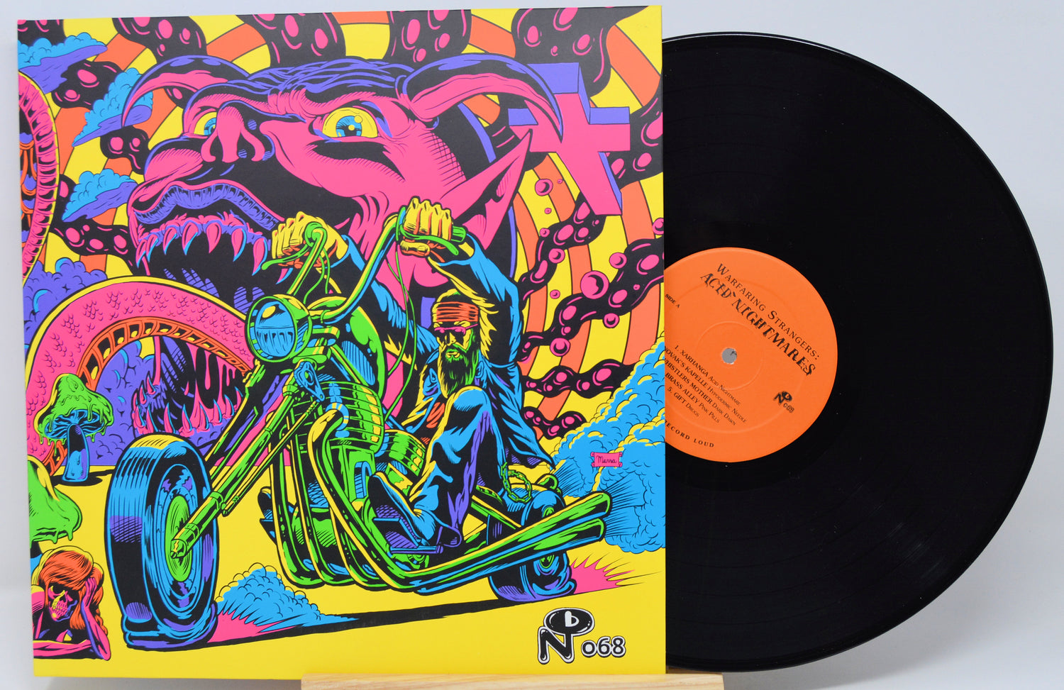 Vinyl record with a colorful cover featuring a motorcycle and abstract design.