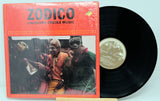 Vinyl record with red cover featuring two people and 'Zodico Louisiana Creole Music' text.