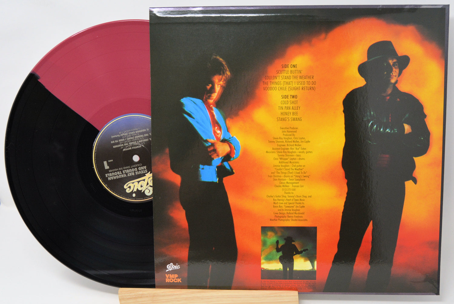 Vinyl record with a colorful cover featuring silhouettes of people against an orange and red background.