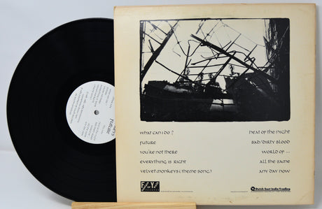 Vinyl record with cover featuring black and white artwork and text.