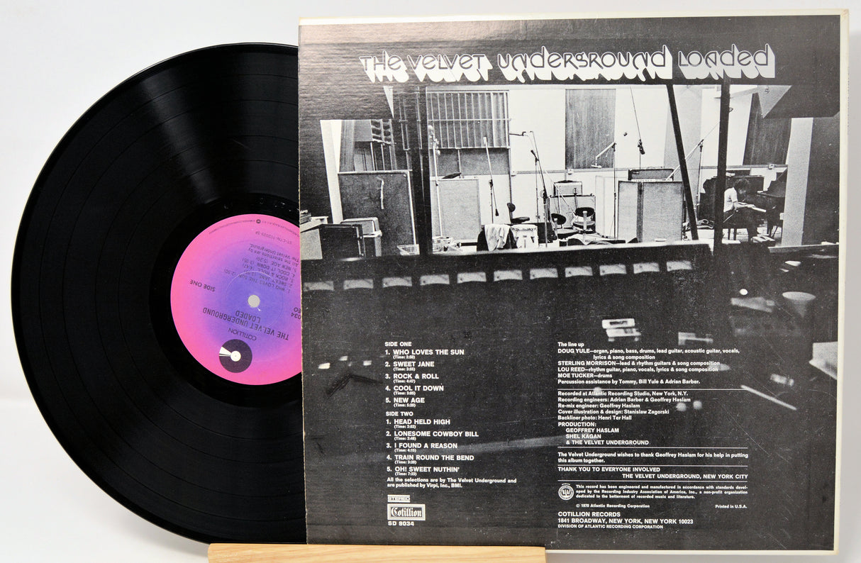 Vinyl record with a cover showing a black and white interior scene, likely of a recording studio.
