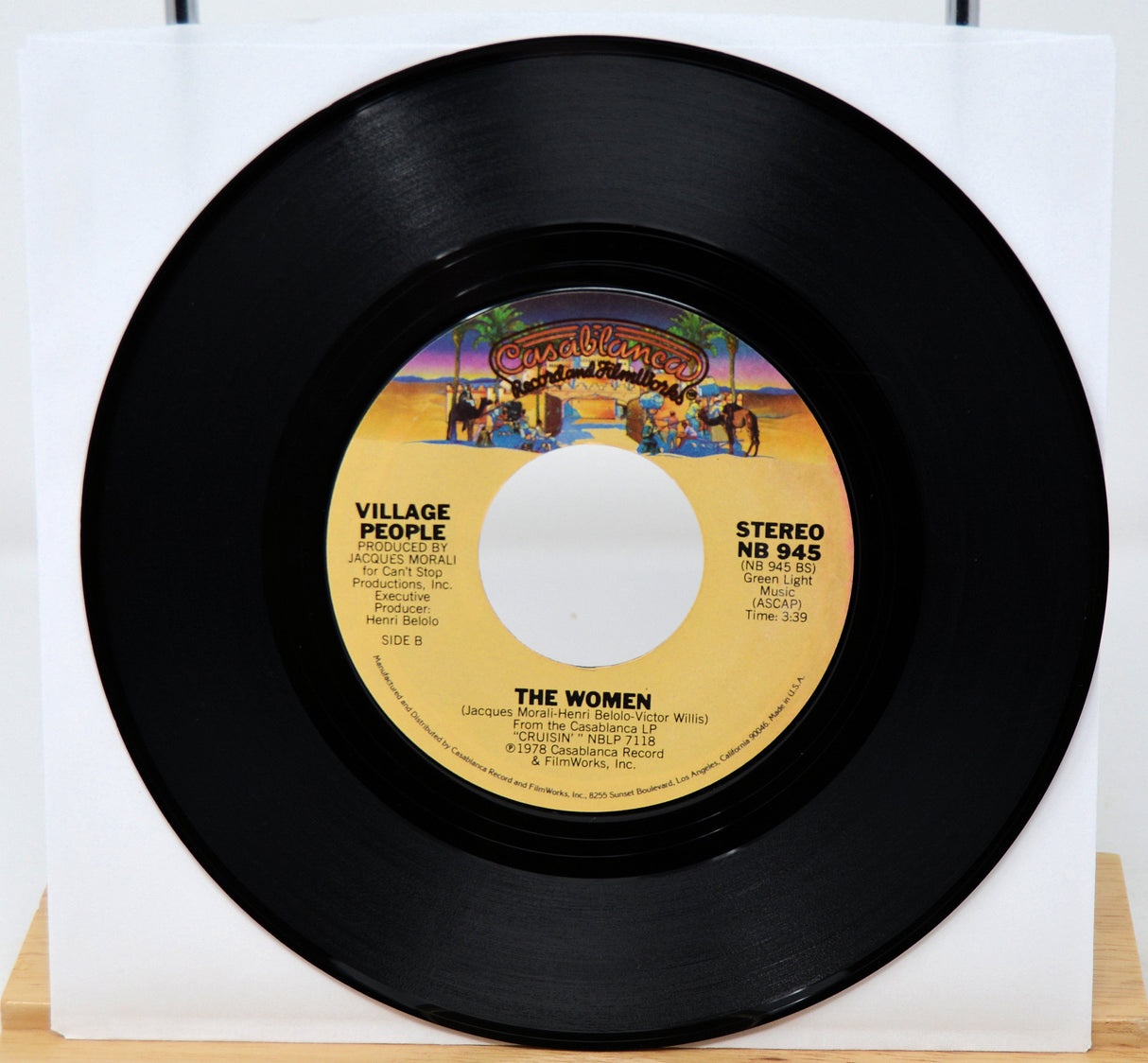 Vinyl record with a colorful label featuring the Village People on a white background