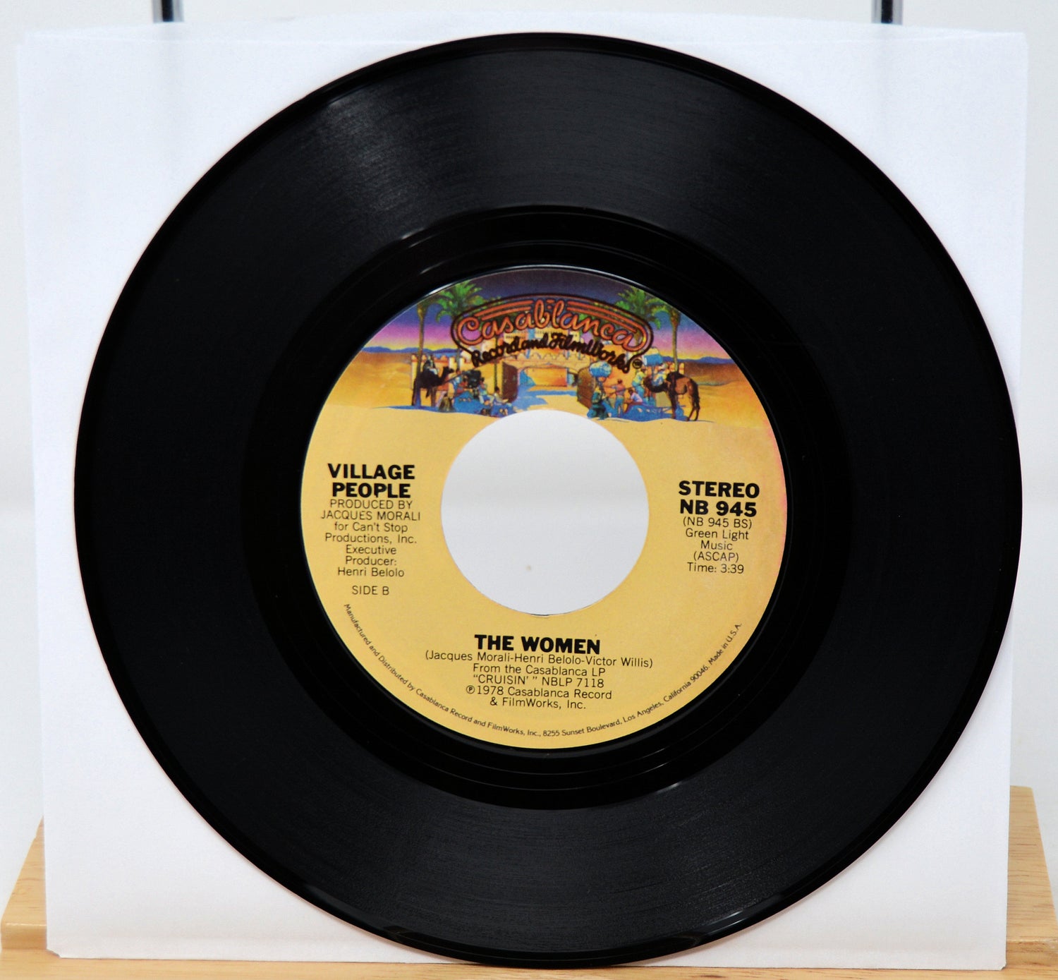 Vinyl record with a colorful label featuring the Village People on a white background