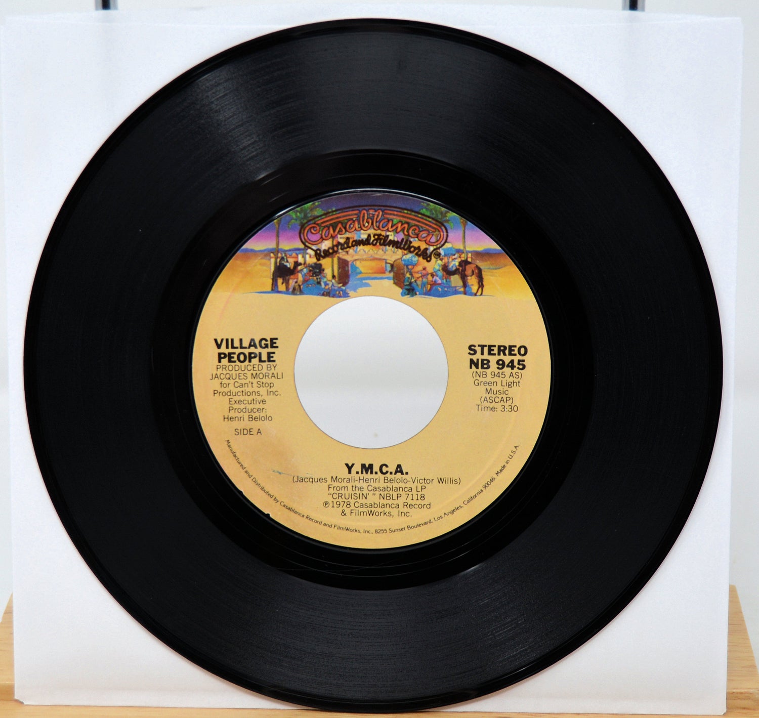 Vinyl record with yellow label featuring 'Y.M.C.A.' by the Village People on a white background.