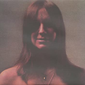 Atmospheric vintage portrait of a woman with long hair and a soft, retro filter
