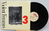 Vinyl record with 'Violent Femmes' album cover showing three people and a red number 3.