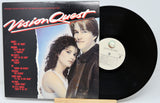 Vinyl record with cover featuring two people and 'Vision Quest' text on a white background