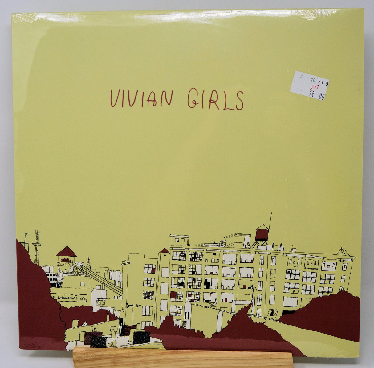 Front cover of Vivian Girls self-titled vinyl with building artwork and band name
