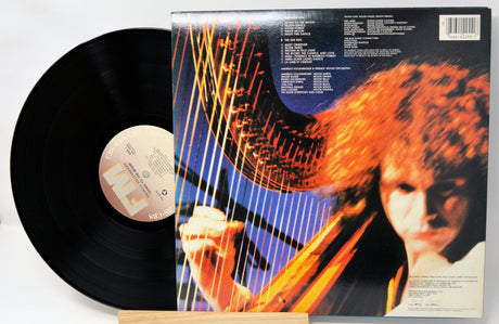 Vinyl record with a colorful cover featuring a person playing guitar