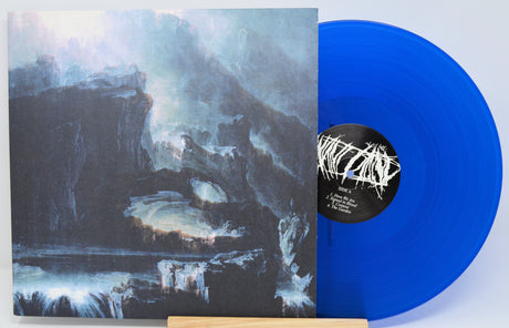 Back cover and blue vinyl of WILT's 'Beneath' LP featuring moody landscape artwork