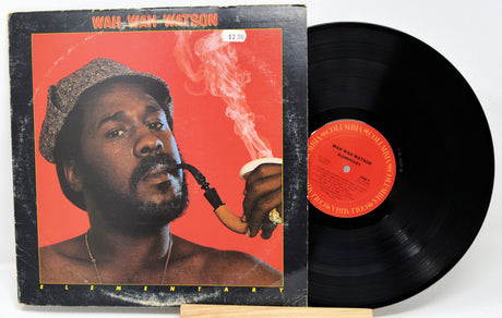 Front cover of Wah Wah Watson's 'Elementary' album with vinyl record and artist smoking pipe
