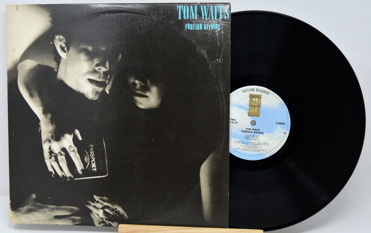 Vinyl record with cover featuring a black and white image of a man and woman, with a visible label.