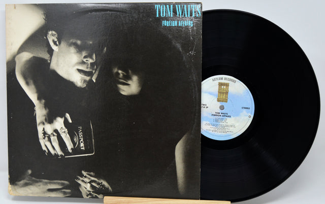 Vinyl record with cover featuring a black and white image of a man and woman, with a visible label.
